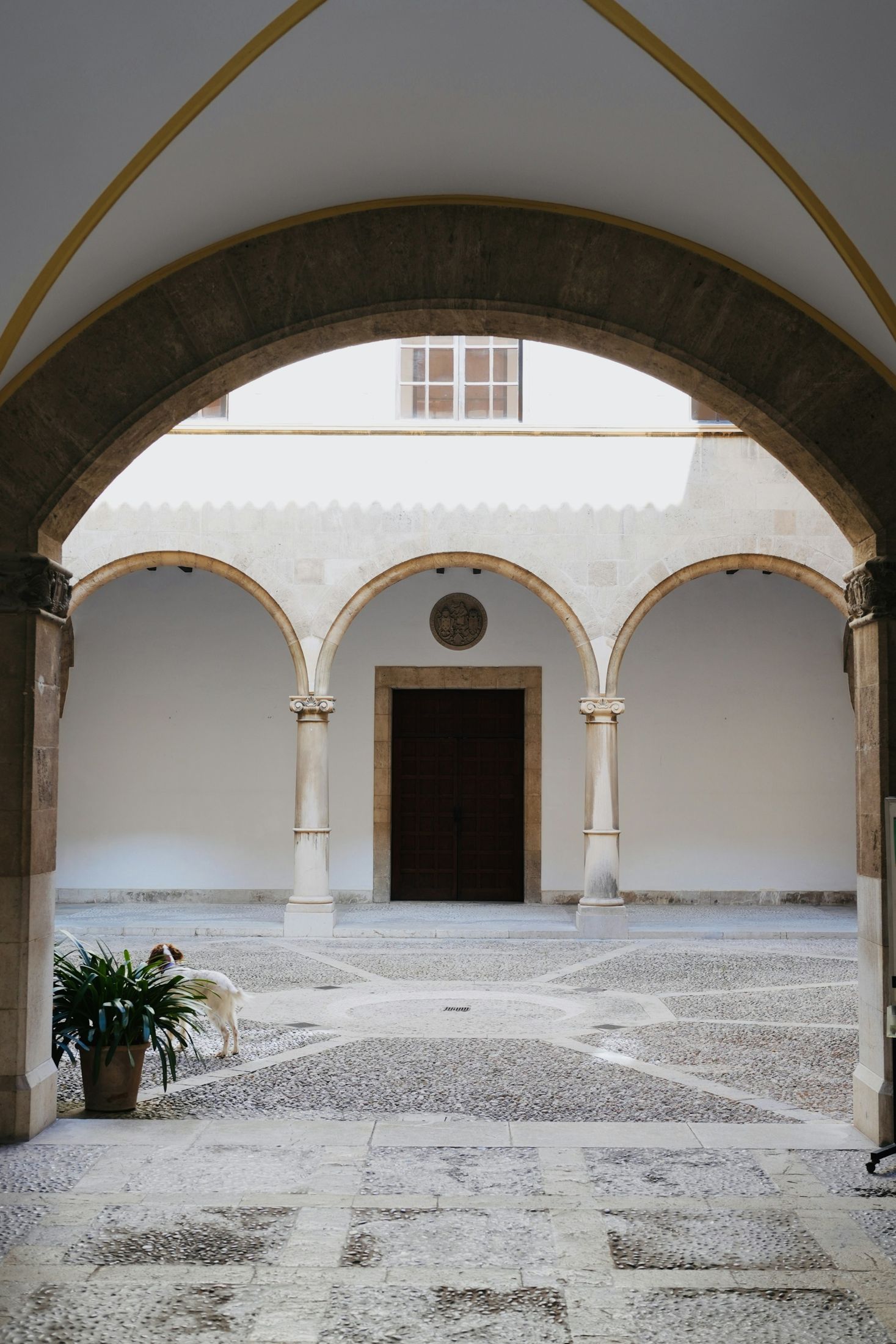 Stone arches and columns around a traditional courtyard in Mallorca, Spain
