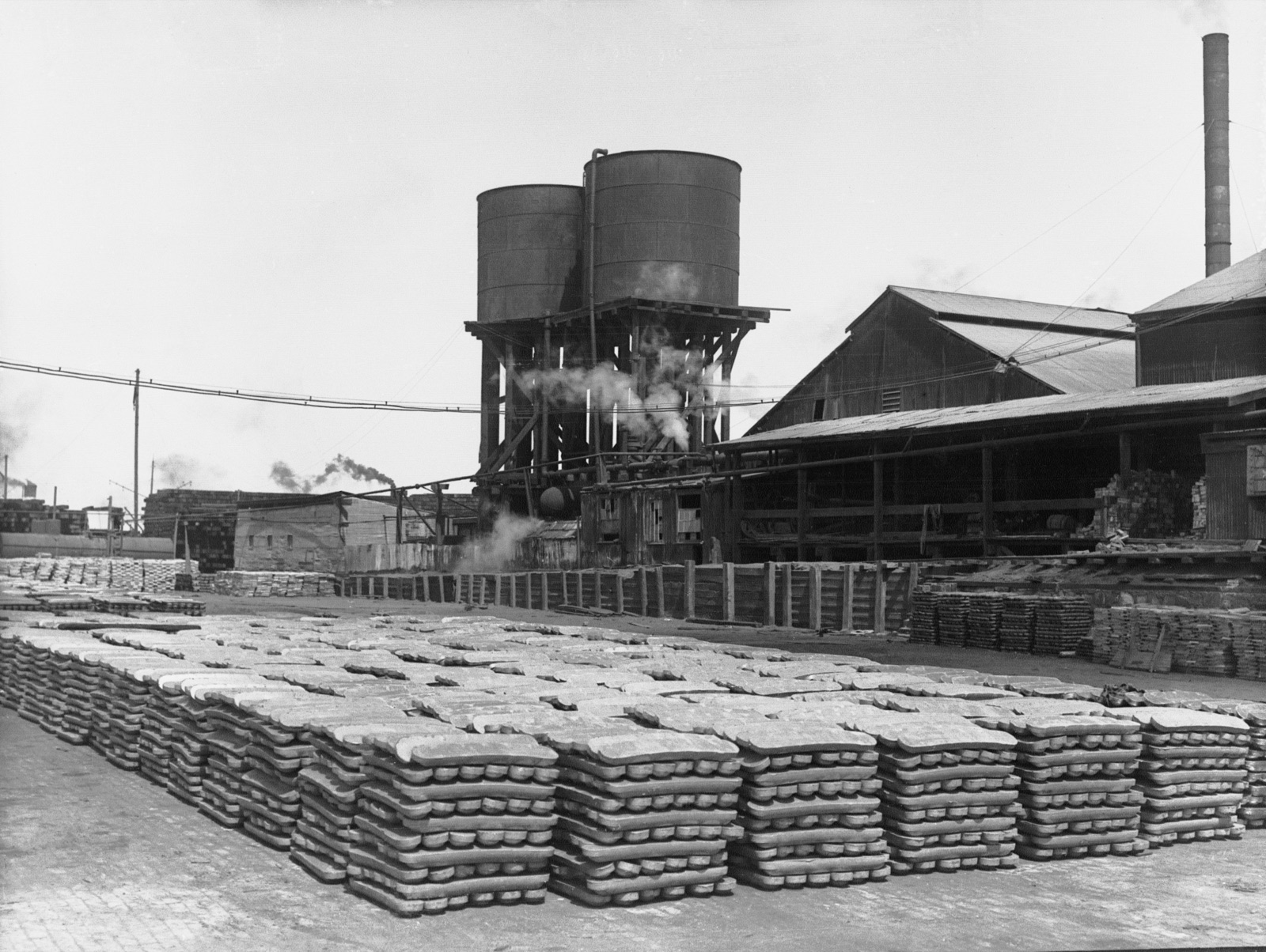 Archival photograph of lead ingots stacked at a smelter in Port Pirie, Australia, circa 1925